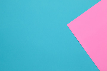 Blue and pink pastel papers geometric lay as background.