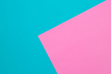 Blue and pink pastel papers geometric lay as background.