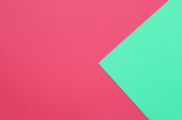 Red and green pastel papers geometric lay as background.
