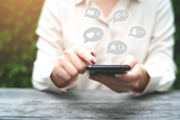 Technology and social network concept, Woman with smart phone and icons on background.