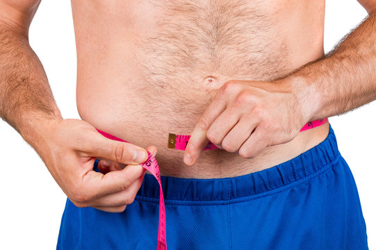 Male torso and red tape measure on white background