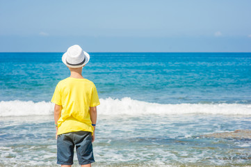 Little boy enjoying on the beach. Space for text