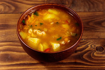 Kharcho soup with meat and rice on wooden table
