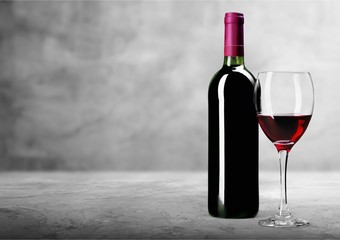 Red wine glass and buttle on wooden desk background