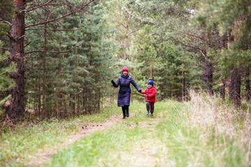 Fototapeta premium Granny and little grandson run on forest