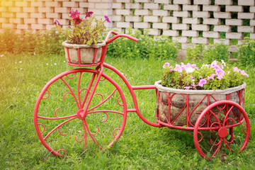 Fototapeta na wymiar Decor for the garden and flowers as a bicycle