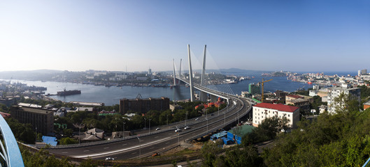 Golden cable-stayed bridge road car traffic from above. Modern Vladivostok Russia night...