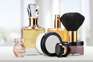 Perfume bottles and cosmetics with brush isolated on white