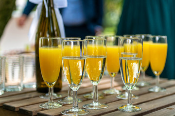 sparkling wine in glasses with orange juice in restaurant or on a party dinner setting
