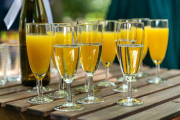 sparkling wine in glasses with orange juice in restaurant or on a party dinner setting