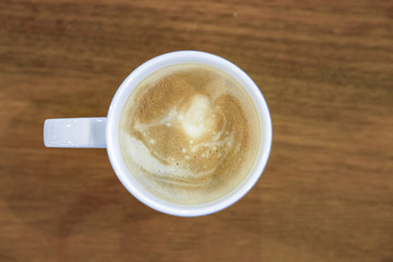 Cup of coffee on wooden table