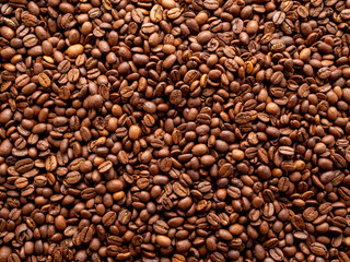 Close-up roasted coffee beans background, top view, copy space