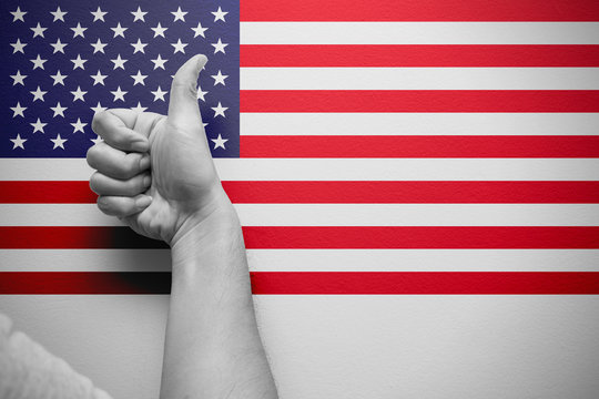 good america thumb up hand with american flag background