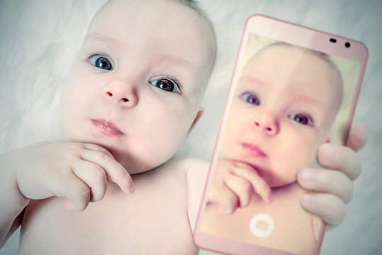 Funny baby girl make selfie on mobile phone