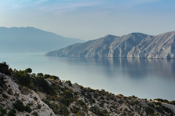 Fototapeta na wymiar Nice calm sea with cliffs and hills, island Krk, Croatia