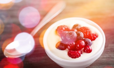 Yogurt with forest berries  on wooden table