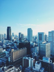 Fototapeta na wymiar Up in the sky overlooking Osaka, Japan on a sunny day