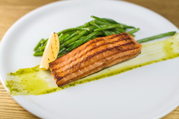 Grilled salmon with asparagus on a white plate