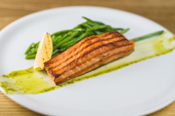Grilled salmon with asparagus on a white plate