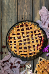 Traditional American cherry pie on a dark wooden background