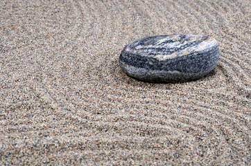 Fototapeta na wymiar Zen composition. Garden of stones.Calming patterns on the sand.