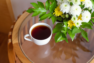 Cup of coffee on the bedside table. Home interior