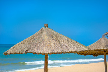 Beach beautiful thatched umbrellas and bright turquoise sea, great recreation and relaxation. tropical paradise.