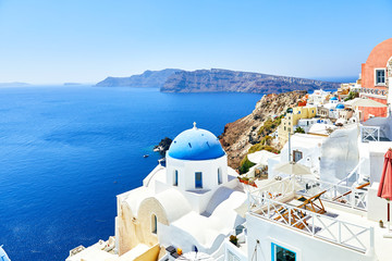 Fototapeta premium white houses with blue roofs on Santorini