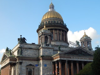 Fototapeta na wymiar The golden dome of St. Isaac's Cathedral in St. Petersburg against the blue sky