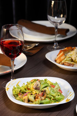 luxury dinner served on the table with glass of red wine