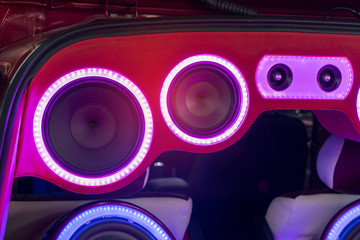 colorful lights of stereo and speakers in car in the night