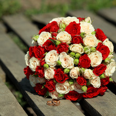 top view of luxury bouquet of red and white flowers on pallet. top view with red bow on wedding day holiday