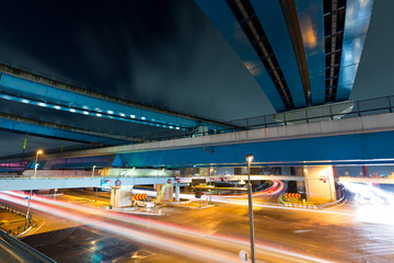 Traffic under highway at night