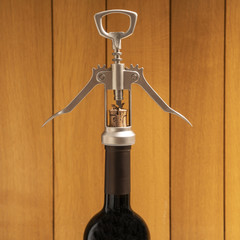 open a bottle of wine with a corkscrew