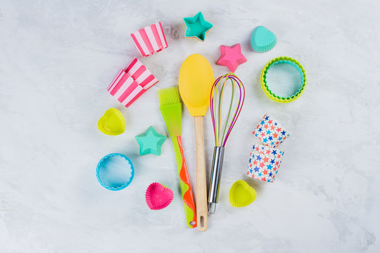 ?olorful Rainbow Kitchen utensils for bakery on white marble table background. Top view