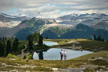 People hiking in mountains near beautiful alpine lakes and glaciers. Elfin lakes in Garibaldi Park...