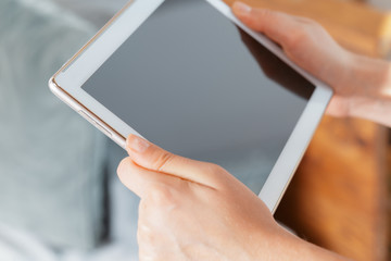 woman holding digital tablet, closeup