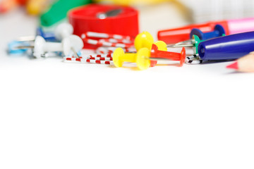 Overhead shot of school supplies on white background.