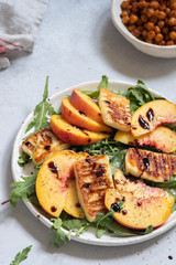 Green salad with grilled halloumi cheese and peaches