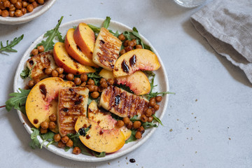 Green salad with grilled halloumi cheese and peaches