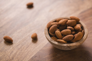 peeled almonds in wood bowl