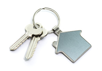 Key and keychain in the shape of a house isolated on white background.