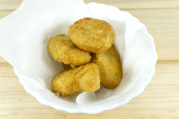 Chicken nuggets in white cup on wooden background,copy space.