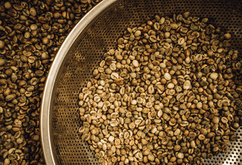 green raw coffee beans being sorted out 