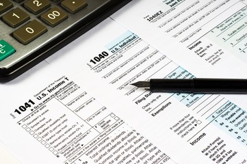 Tax Form 1040 1041 1040EZ pen and calculator