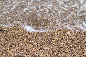 texture of sea pebbles by the sea view from the top