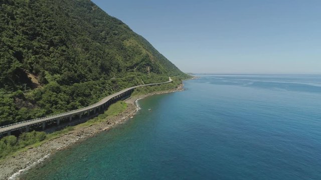 Aerial view of Patapat viaduct in the coast of Pagudpud, Ilocos Norte. Highway with bridge by coast sea near the mountains. Philippines, Luzon. Highway along the coast.