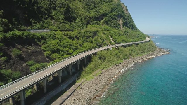 Aerial view of Patapat viaduct in the coast of Pagudpud, Ilocos Norte. Highway with bridge by coast sea near the mountains. Philippines, Luzon.