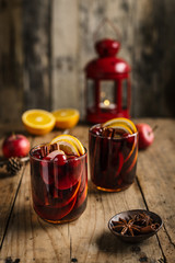 Mulled wine in glass on old rustic table