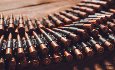 Bullets on wooden background.